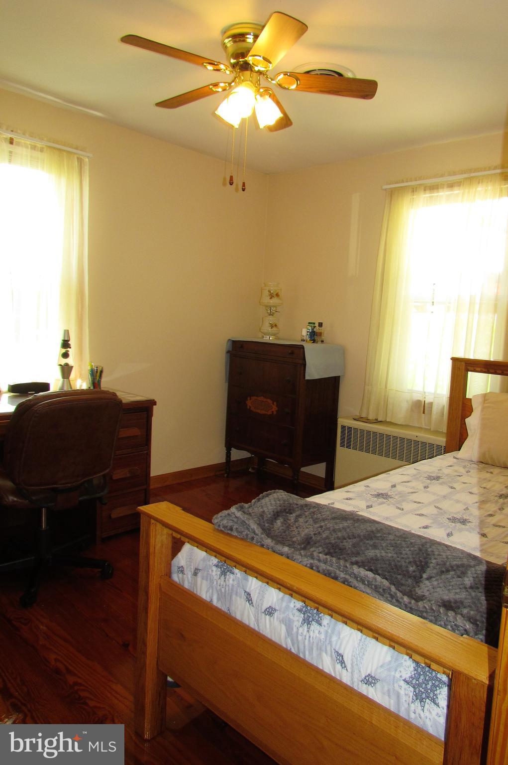 6442 Mt Phillip Road Frederick, MD 21703 - Photo 14 of 37 a bedroom with a bed and a dresser