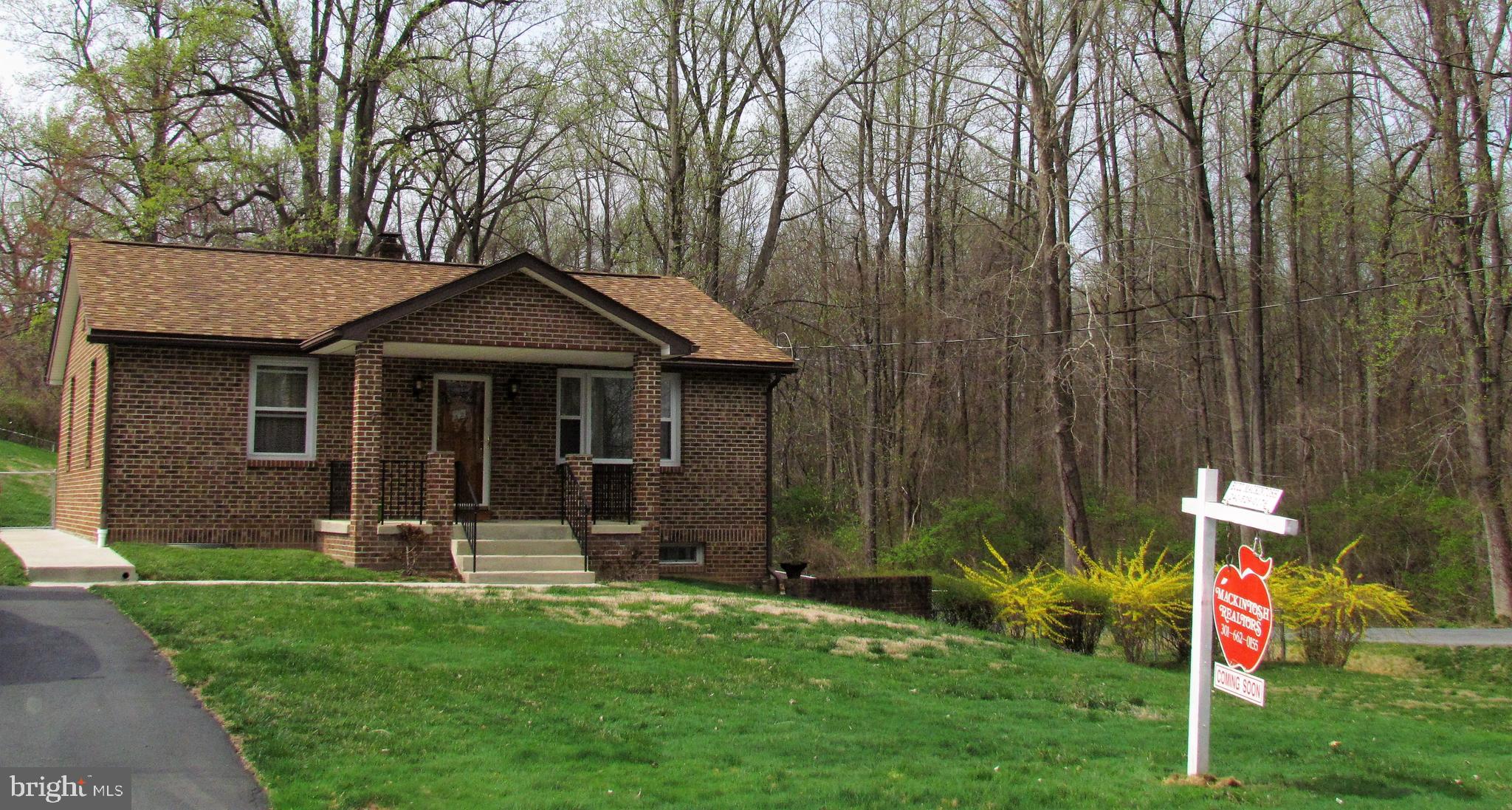 6442 Mt Phillip Road Frederick, MD 21703 - Photo 4 of 37 a front view of a house with a yard and trees