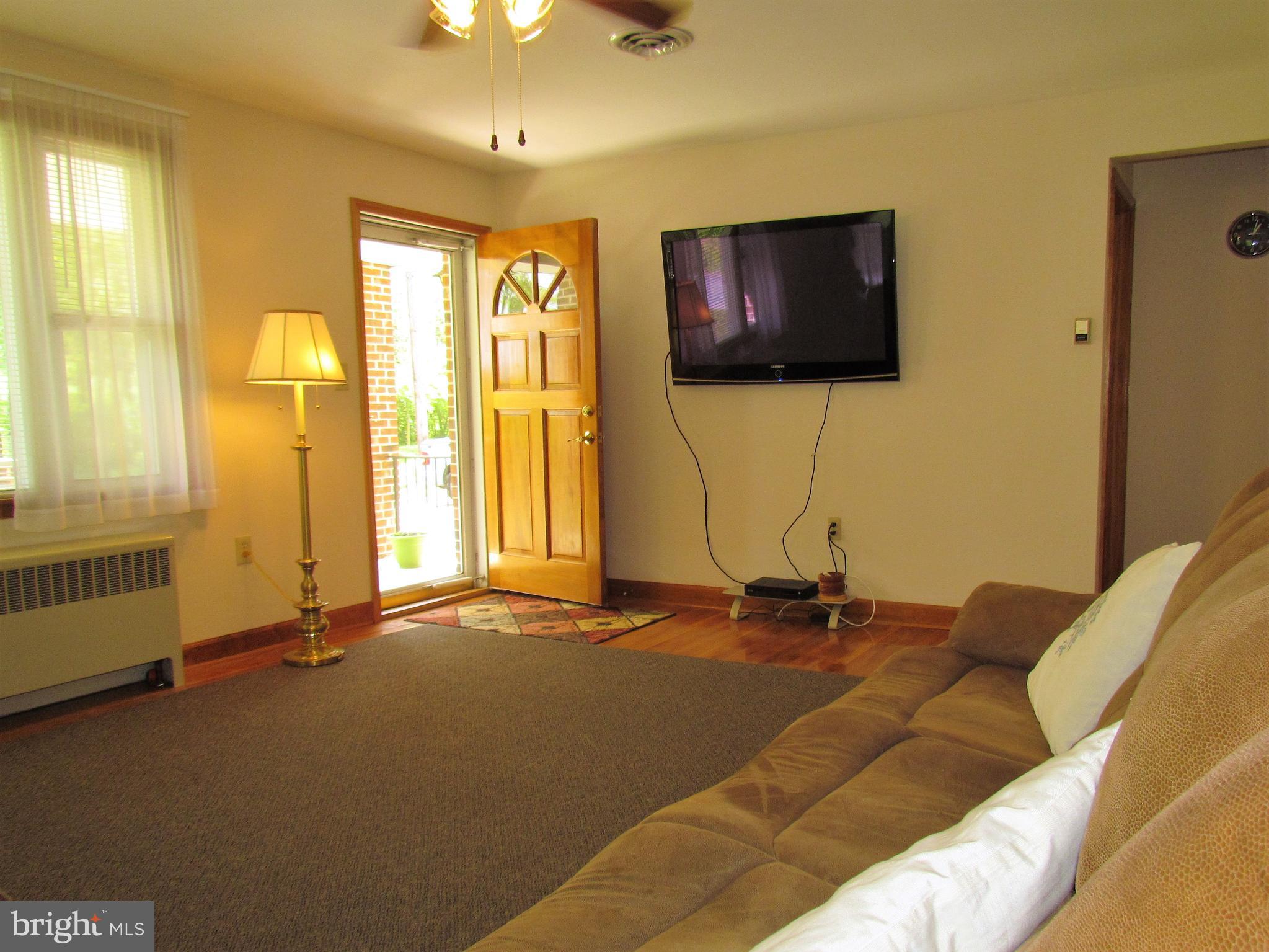 6442 Mt Phillip Road Frederick, MD 21703 - Photo 5 of 37 a bedroom with a bed and a flat screen tv