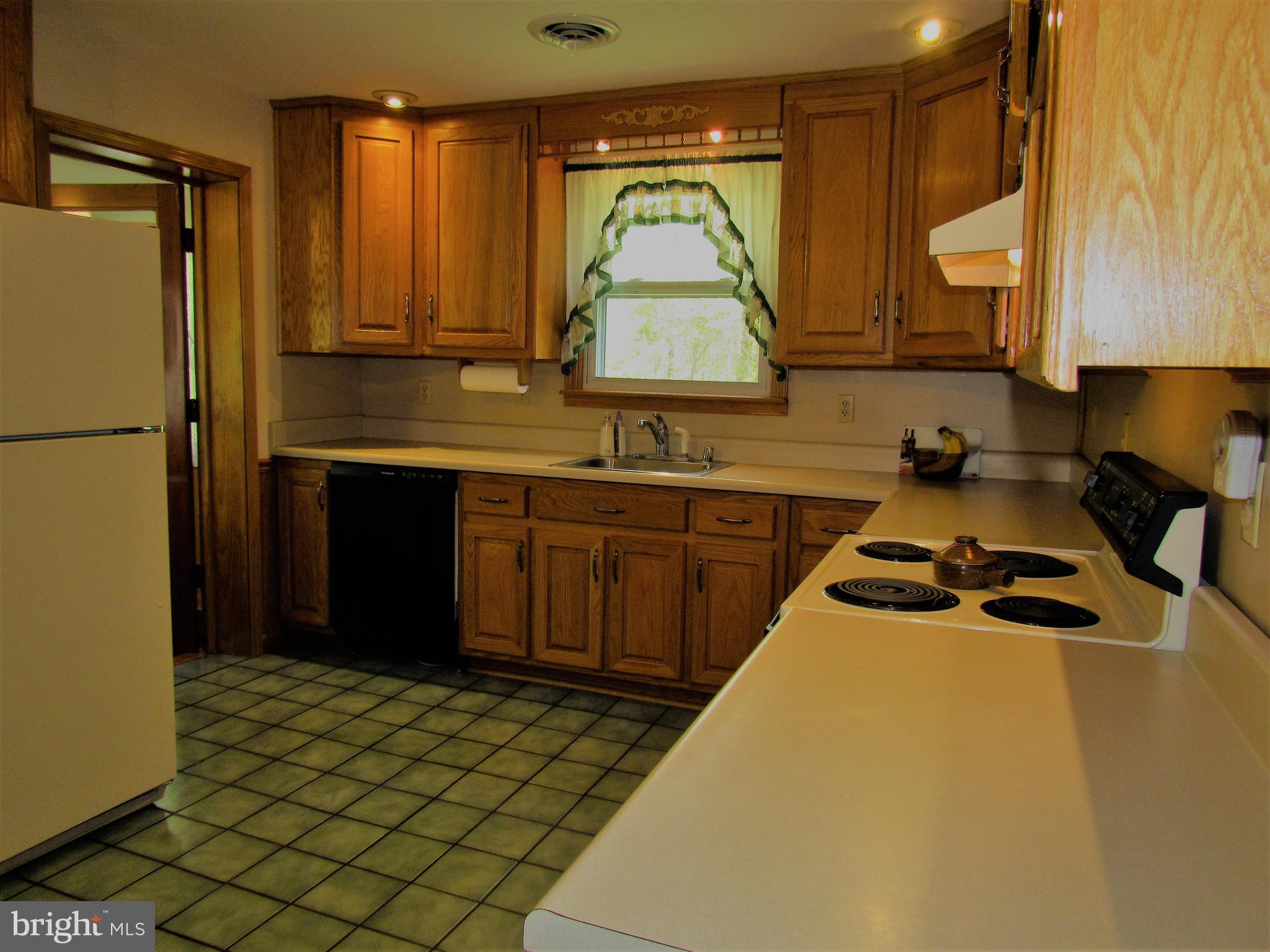6442 Mt Phillip Road Frederick, MD 21703 - Photo 8 of 37 a kitchen with a sink a stove and cabinets
