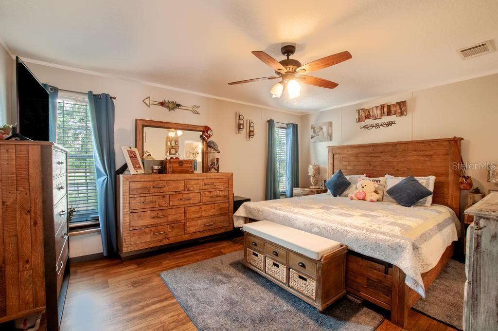1264 Northeast Forrest Avenue Arcadia, FL 34266 - Photo 11 of 25 a bedroom with a bed and a chandelier