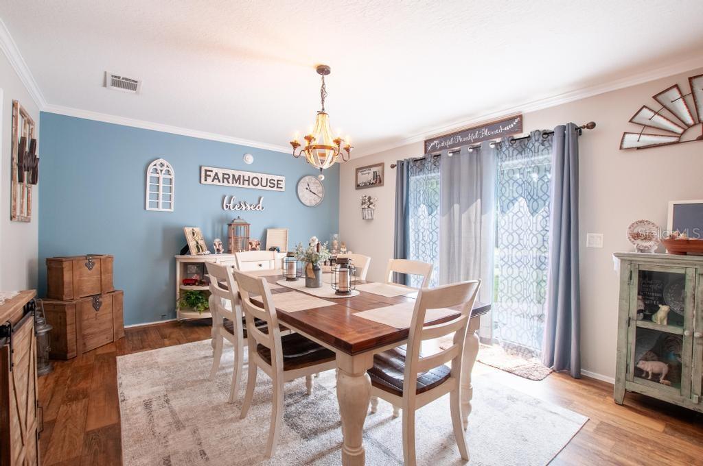1264 Northeast Forrest Avenue Arcadia, FL 34266 - Photo 13 of 25 a view of a dining room and livingroom with furniture wooden floor a chandelier