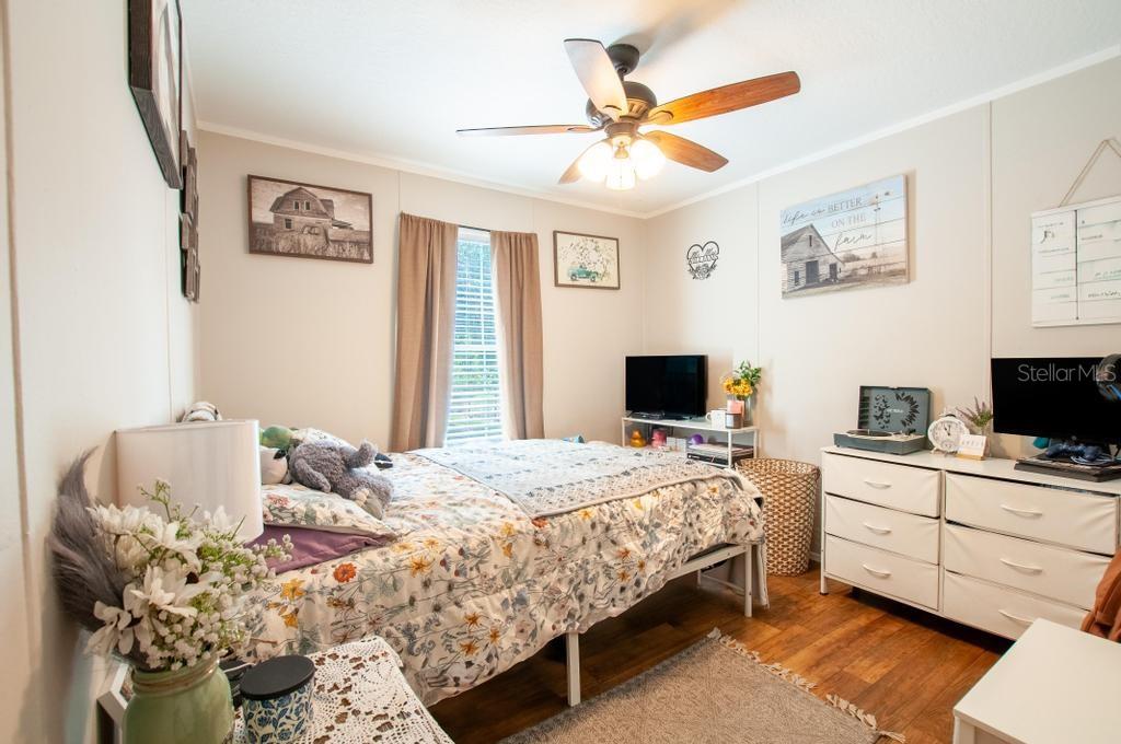 1264 Northeast Forrest Avenue Arcadia, FL 34266 - Photo 15 of 25 a bedroom with a bed and a flat screen tv