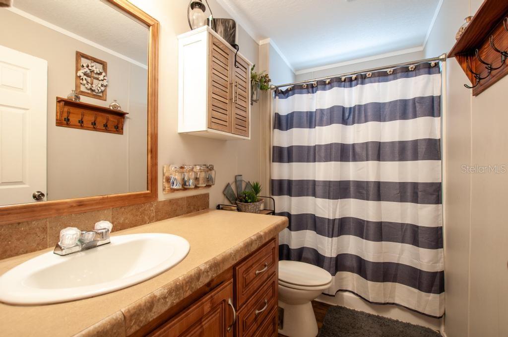 1264 Northeast Forrest Avenue Arcadia, FL 34266 - Photo 16 of 25 a bathroom with a sink toilet and shower