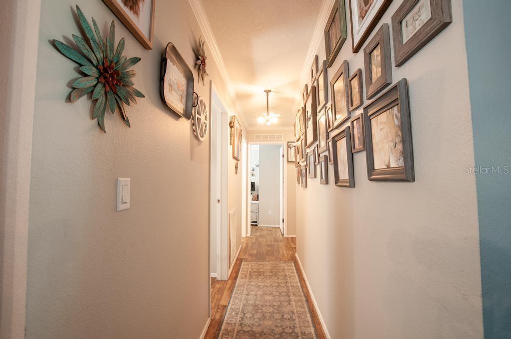 1264 Northeast Forrest Avenue Arcadia, FL 34266 - Photo 18 of 25 a view of a hallway with paintings on the wall