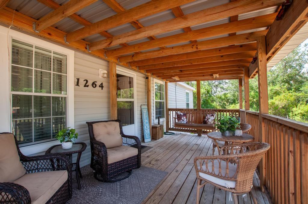 1264 Northeast Forrest Avenue Arcadia, FL 34266 - Photo 19 of 25 a balcony with furniture and wooden floor
