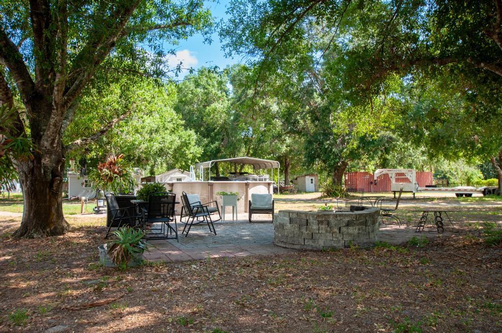 1264 Northeast Forrest Avenue Arcadia, FL 34266 - Photo 22 of 25 a backyard of a house with table and chairs