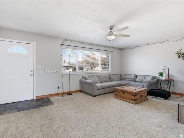 322 East 900 North Logan, UT 84321 - Photo 5 of 43 Carpeted living area featuring a ceiling fan and baseboards