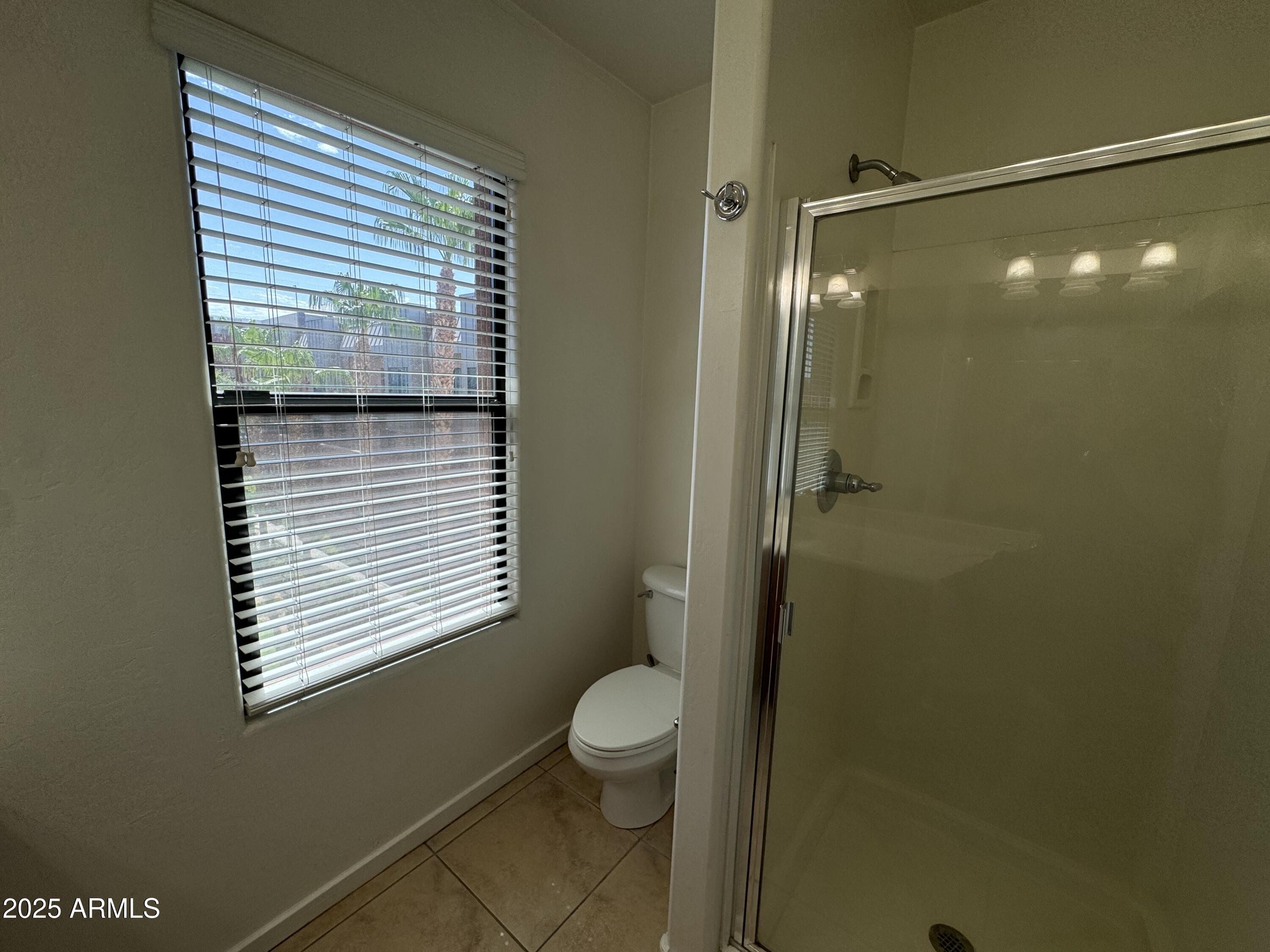 305 South Wilson Street, Unit 111 Tempe, AZ 85281 - Photo 16 of 48 a bathroom with a granite countertop shower a toilet and a window