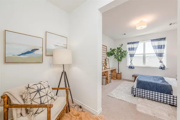 a bedroom with a bed and a potted plant