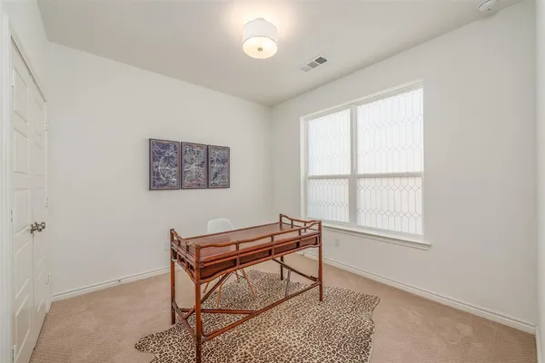 a living room with a couch and piano table