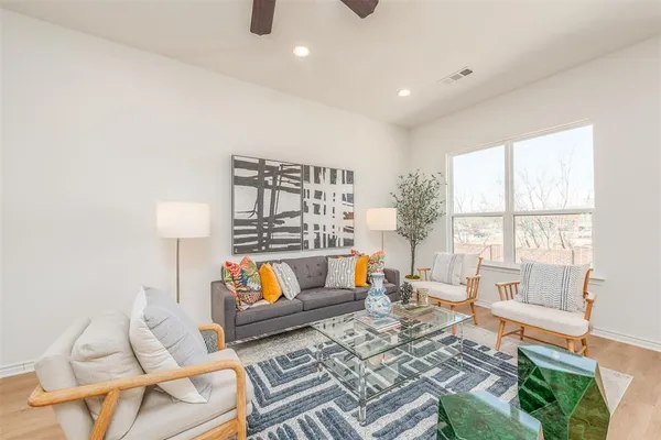 a living room with furniture and a wooden floor