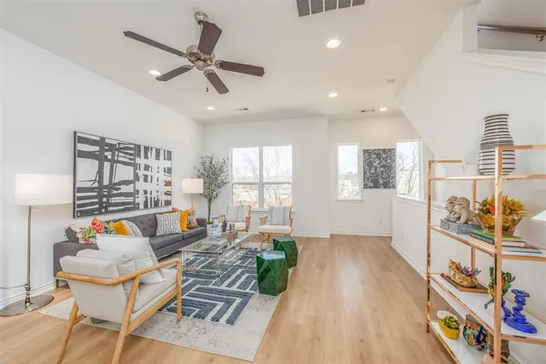 a living room with furniture and wooden floor