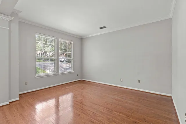 wooden floor in an empty room with a window