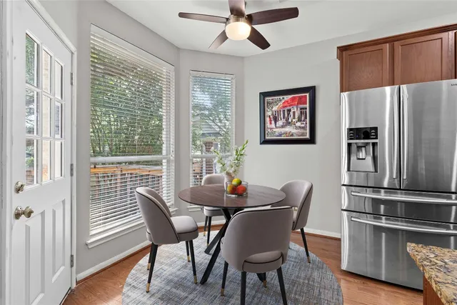 a dining room with furniture a window and wooden floor