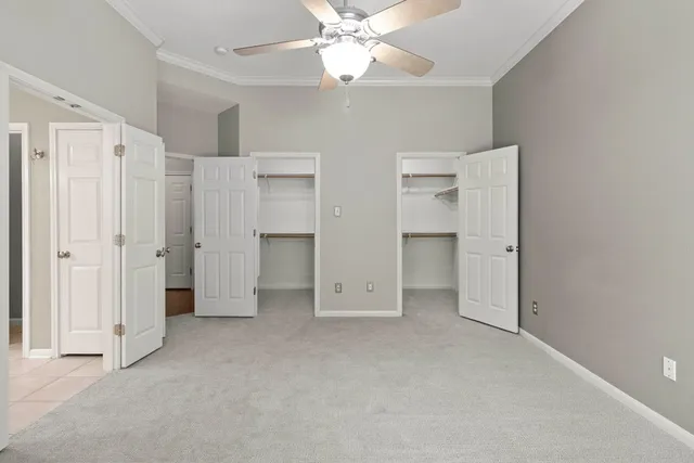 a view of an empty room with a ceiling fan