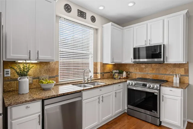 a kitchen with a sink cabinets and microwave