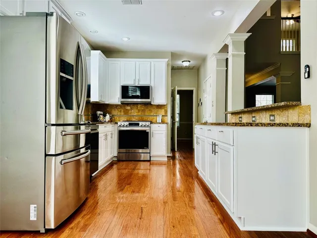 a kitchen with stainless steel appliances a refrigerator stove microwave and sink