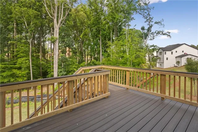 a view of a big house with a big yard and large trees