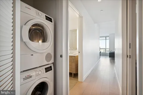 a view of a hallway with washer and dryer