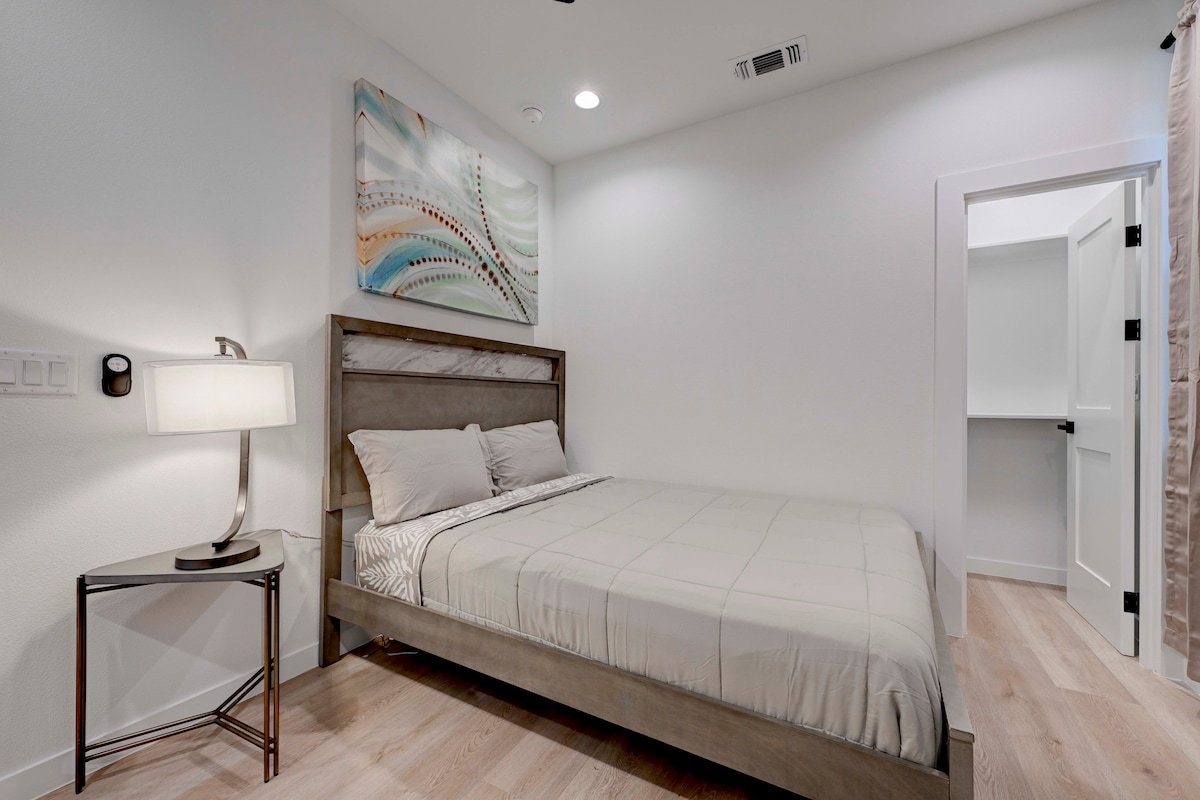 2220 Yellow Jacket Lane, Unit 1 Austin, TX 78741 - Photo 18 of 35 Minimalist bedroom with bright wood-tone flooring and a convenient walk-in closet.