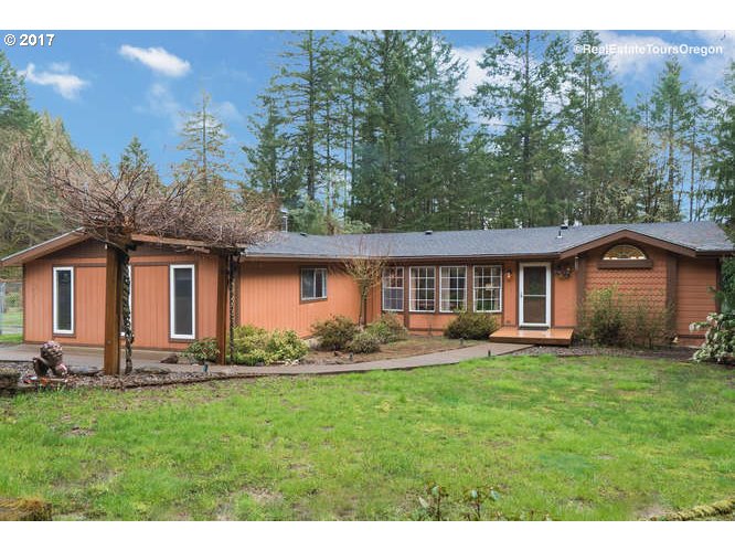 27080 Northwest Olson Road Gaston, OR 97119 - Photo 1 of 32 a front view of a house with a garden and trees
