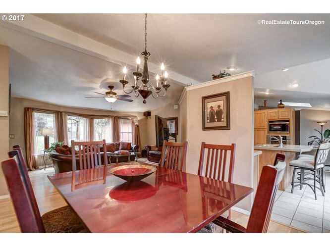 27080 Northwest Olson Road Gaston, OR 97119 - Photo 6 of 32 a view of a dining room with furniture a chandelier and wooden floor