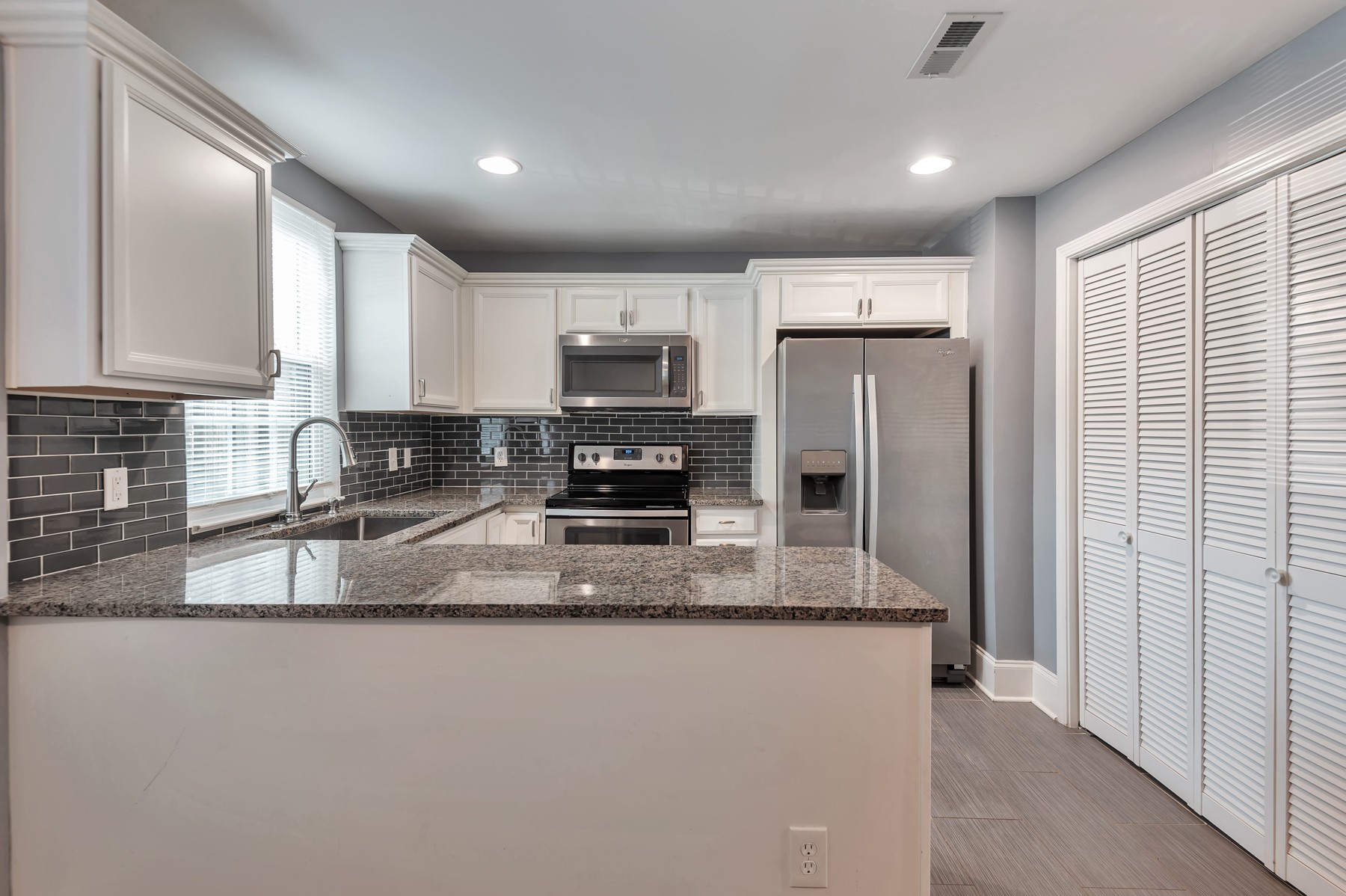 1301 Neelys Bend Road, Unit D27 Madison, TN 37115 - Photo 14 of 26 a kitchen with stainless steel appliances granite countertop a refrigerator a stove top oven a sink and dishwasher