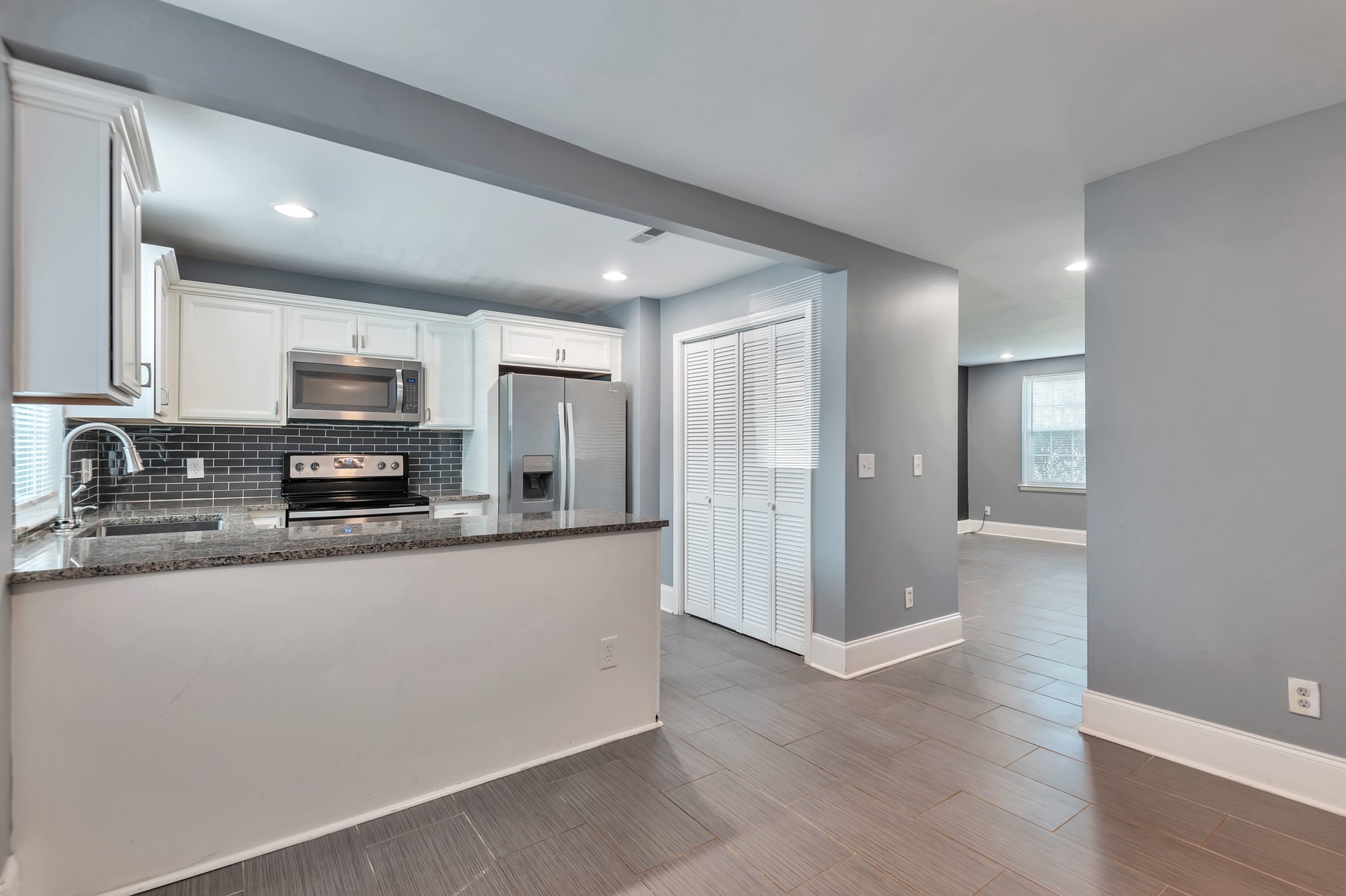 1301 Neelys Bend Road, Unit D27 Madison, TN 37115 - Photo 10 of 26 a large kitchen with granite countertop a large counter top space a sink stainless steel appliances and cabinets