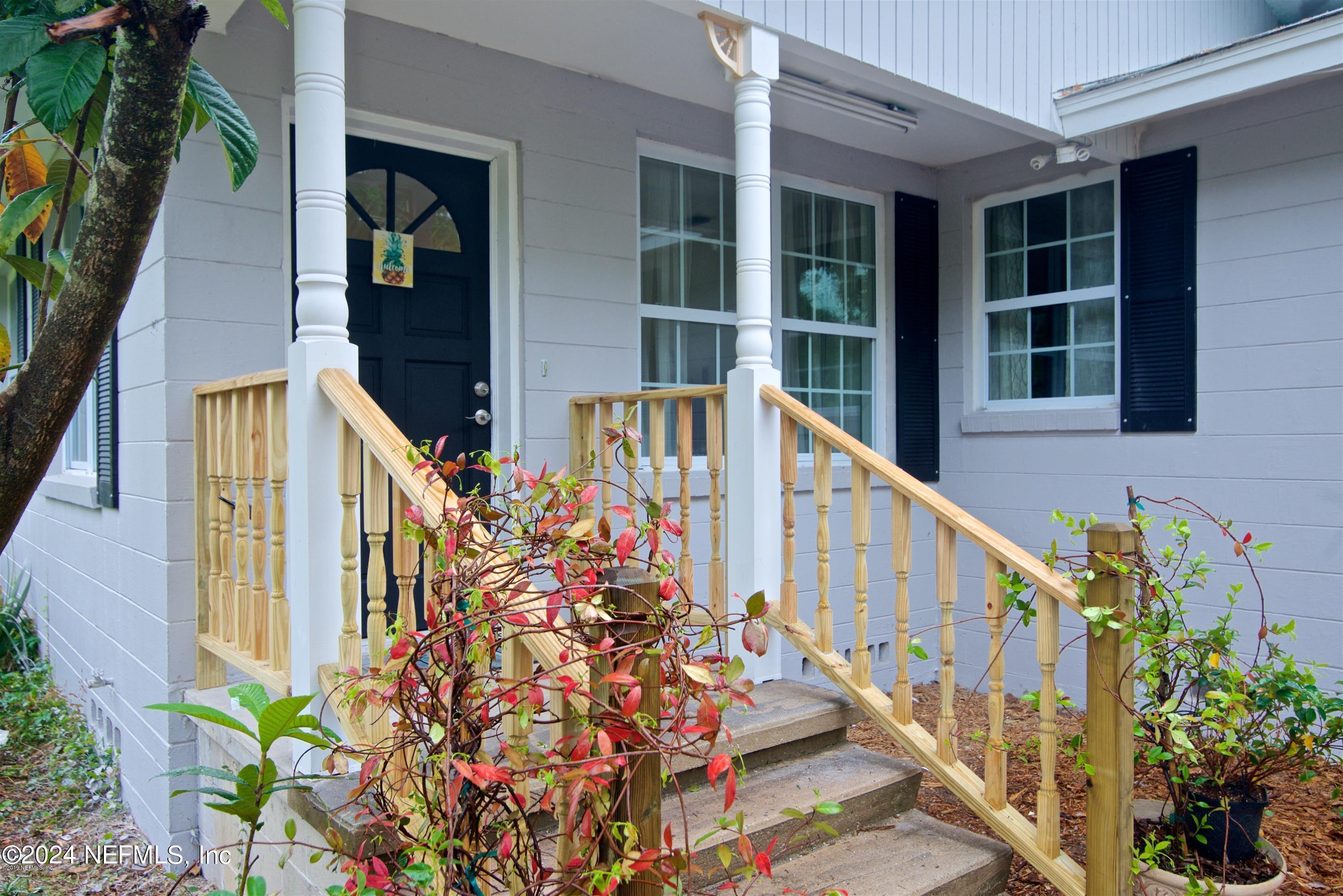 1938 Biggers Road Jacksonville, FL 32216 - Photo 1 of 25 a view of a house with large windows and flower plants