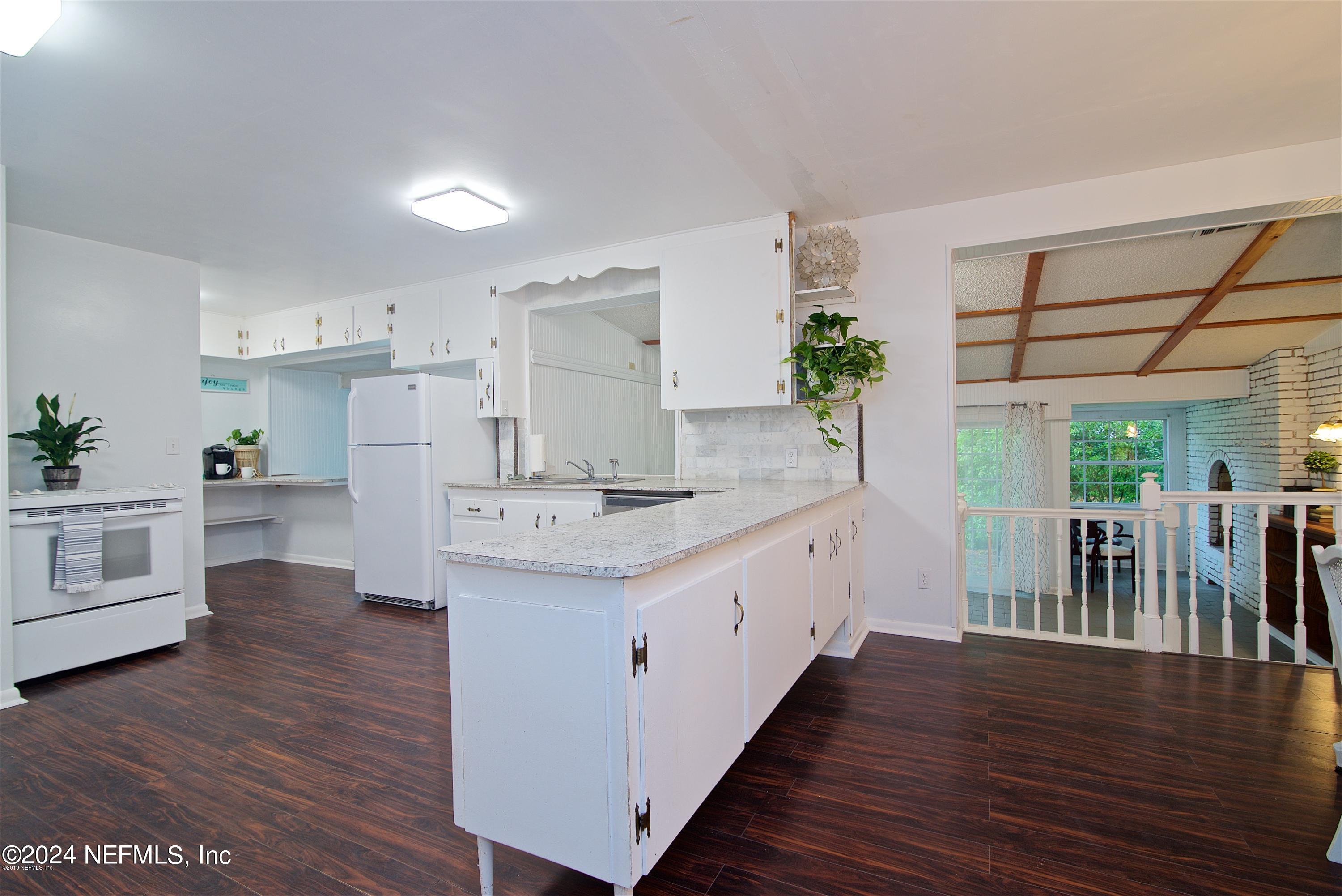 1938 Biggers Road Jacksonville, FL 32216 - Photo 11 of 25 a kitchen with counter top space and wooden floor