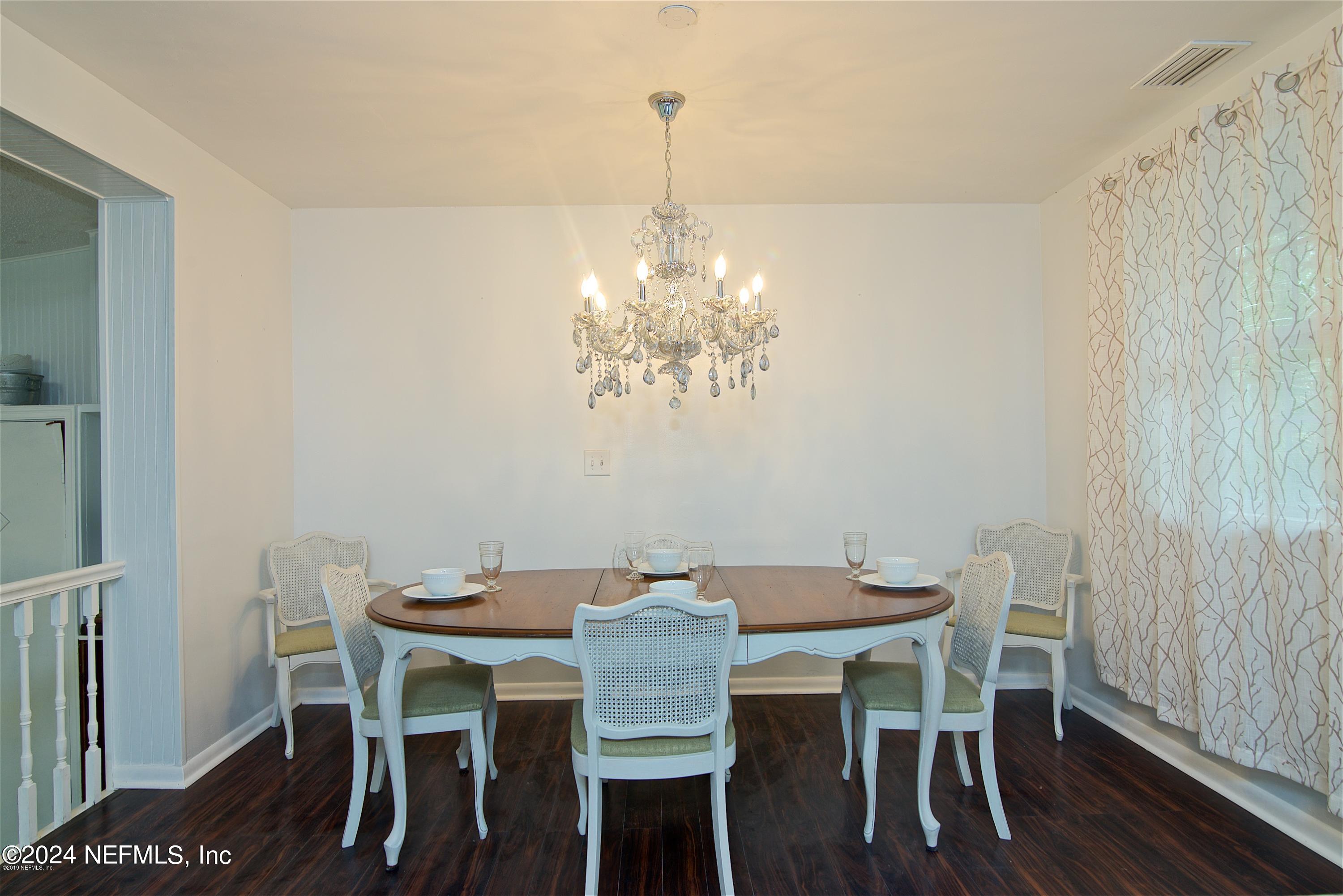1938 Biggers Road Jacksonville, FL 32216 - Photo 14 of 25 a view of a dining room with furniture and wooden floor