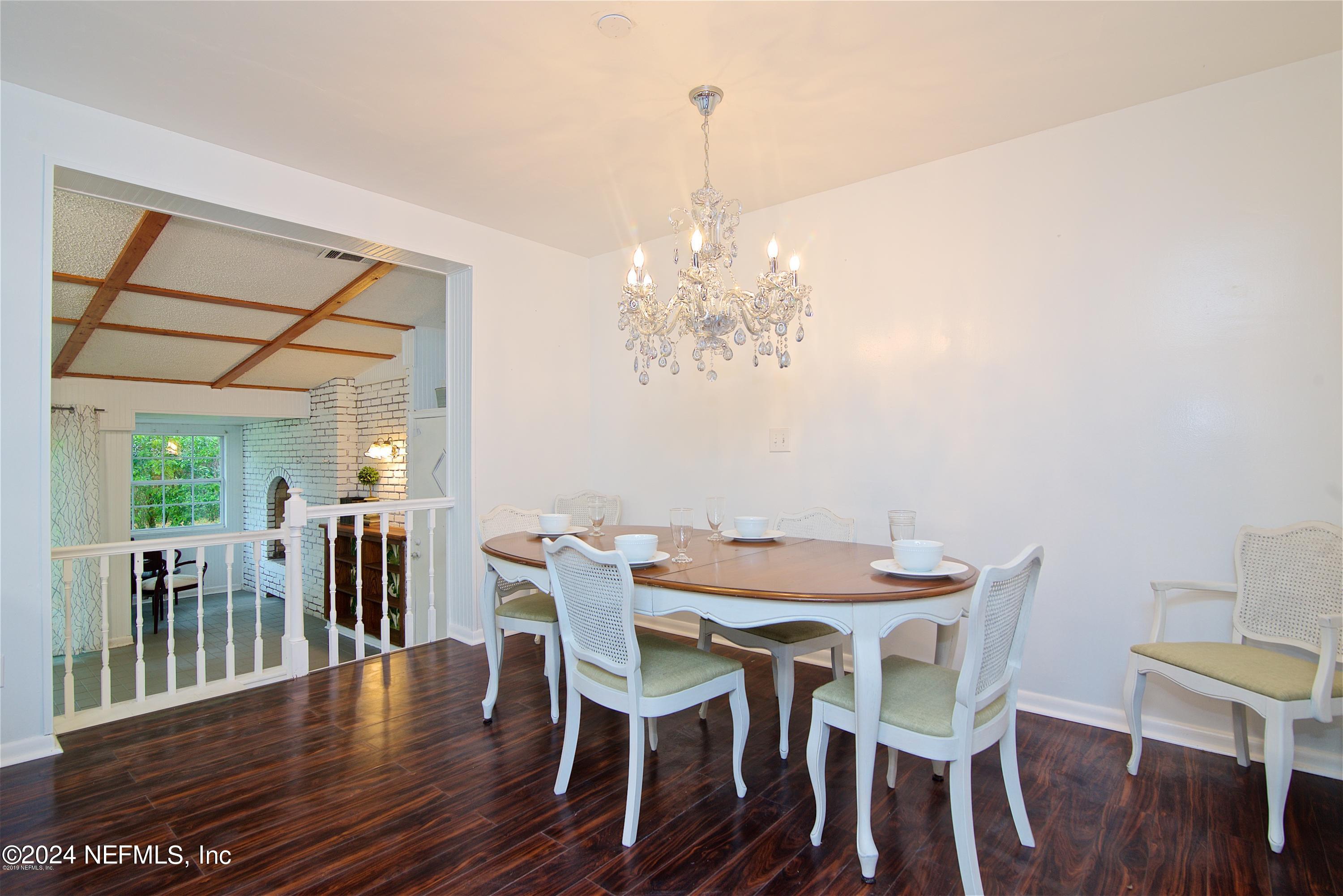 1938 Biggers Road Jacksonville, FL 32216 - Photo 15 of 25 a view of a dining room with furniture wooden floor and chandelier