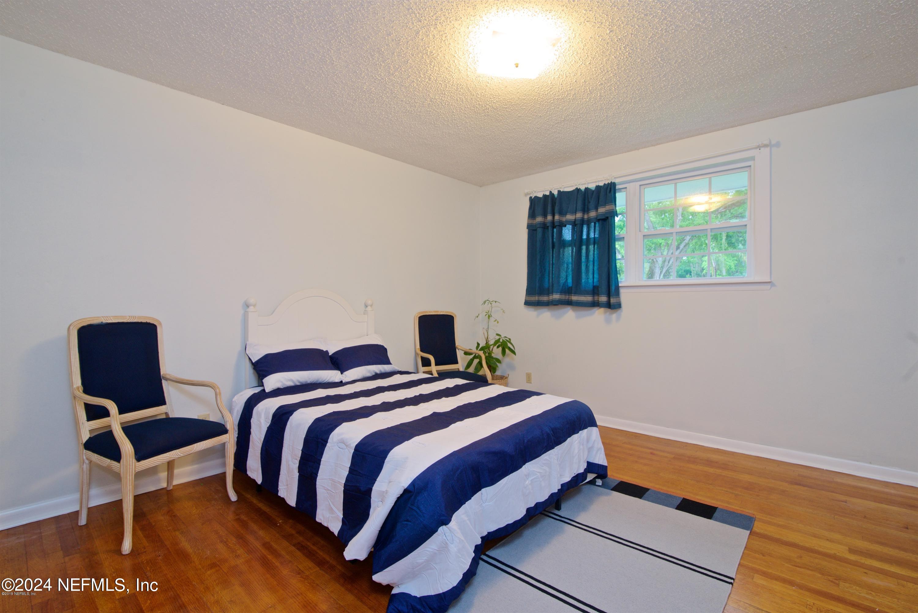 1938 Biggers Road Jacksonville, FL 32216 - Photo 20 of 25 a bedroom with bed and window