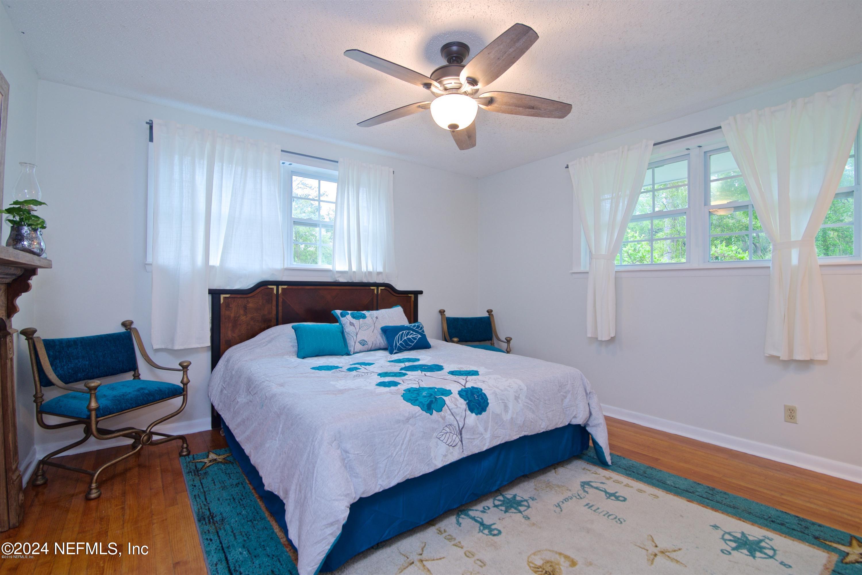 1938 Biggers Road Jacksonville, FL 32216 - Photo 22 of 25 a bedroom with a bed and a chair in it