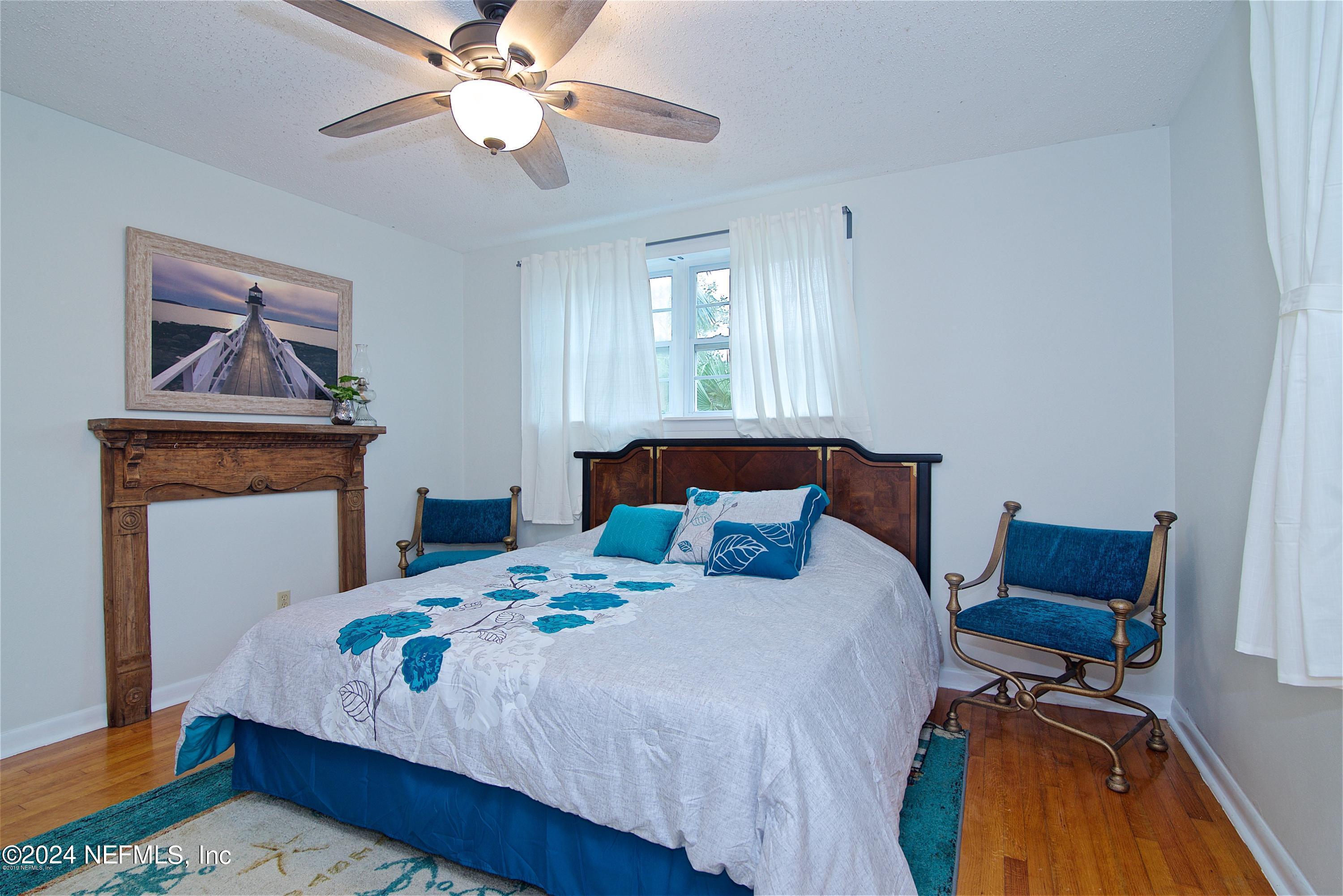 1938 Biggers Road Jacksonville, FL 32216 - Photo 23 of 25 a bedroom with a bed and a chandelier