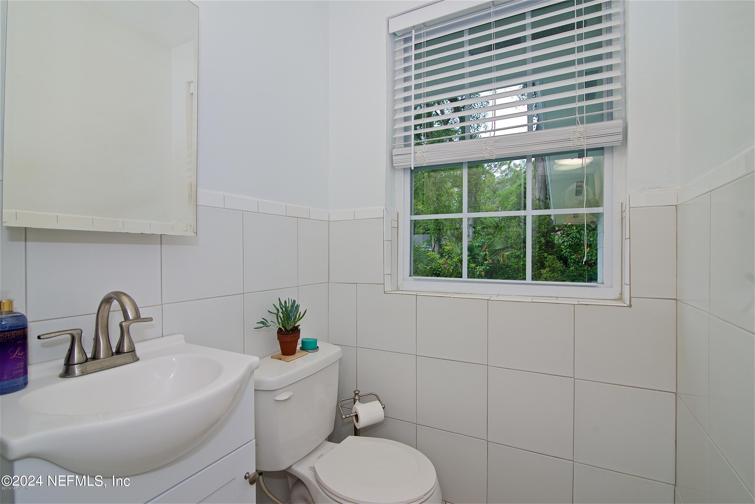 1938 Biggers Road Jacksonville, FL 32216 - Photo 25 of 25 a white toilet sitting next to a bathroom sink