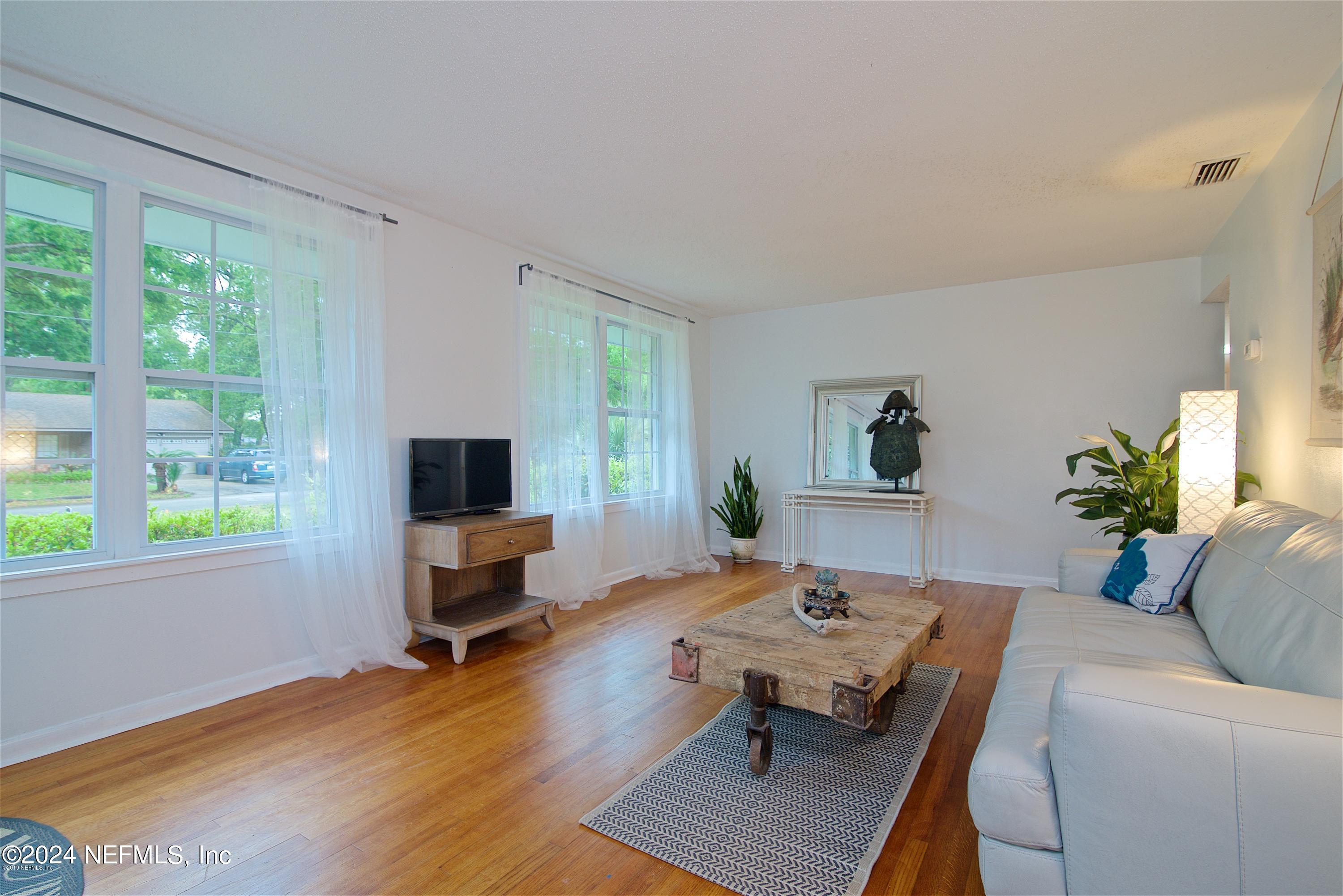 1938 Biggers Road Jacksonville, FL 32216 - Photo 4 of 25 a living room with furniture and a wooden floor