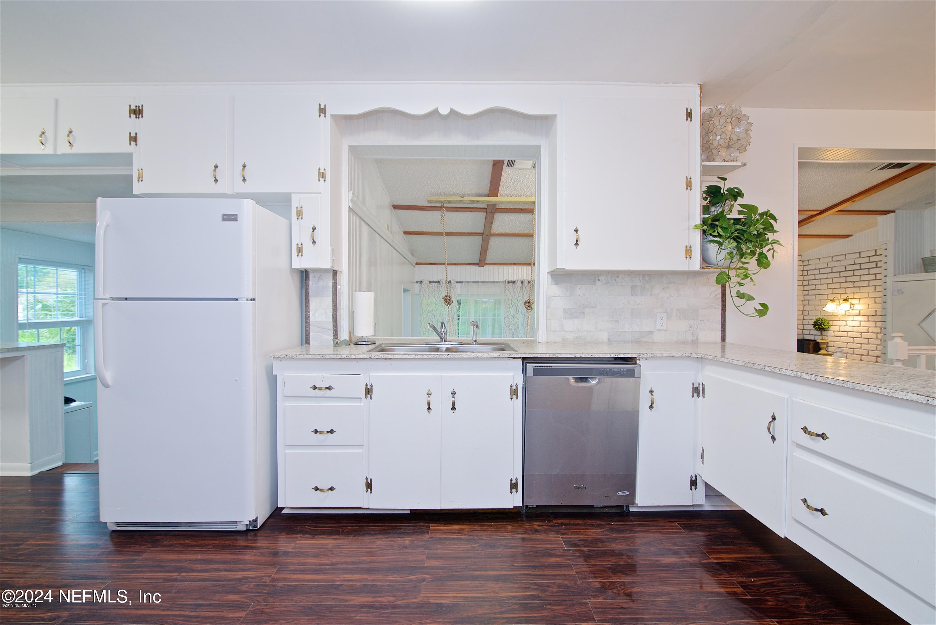 1938 Biggers Road Jacksonville, FL 32216 - Photo 10 of 25 a kitchen with granite countertop white cabinets and white appliances