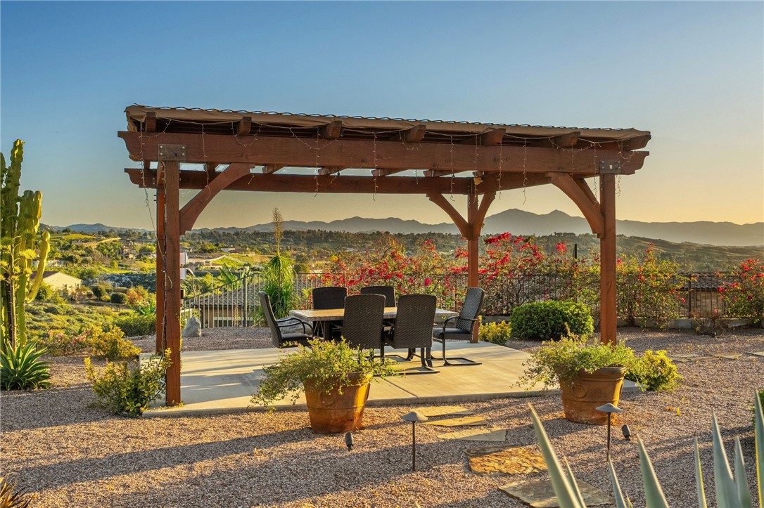7774 Kingdom Drive Riverside, CA 92506 - Photo 12 of 66 Pergola-covered patio provides a private outdoor retreat with seating space and wide-reaching hillside and neighborhood views.