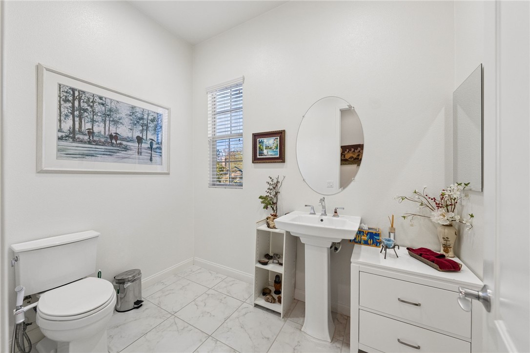 7774 Kingdom Drive Riverside, CA 92506 - Photo 18 of 66 a bathroom with a sink mirror and toilet