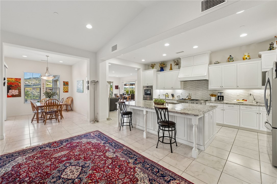 7774 Kingdom Drive Riverside, CA 92506 - Photo 19 of 66 Open-concept kitchen flows seamlessly into the dining space, creating an inviting layout for everyday living and casual entertaining.