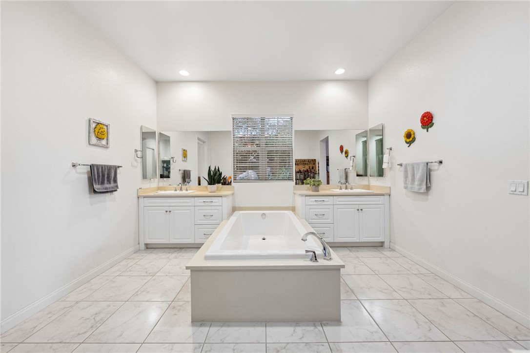 7774 Kingdom Drive Riverside, CA 92506 - Photo 30 of 66 Symmetrical dual-sink vanities and a centrally placed soaking tub create a clean, spa-inspired retreat.
