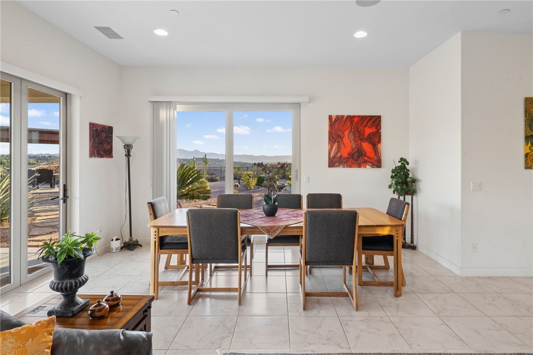 7774 Kingdom Drive Riverside, CA 92506 - Photo 34 of 66 a dining room with furniture potted plants and wooden floor