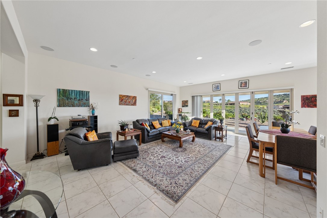 7774 Kingdom Drive Riverside, CA 92506 - Photo 36 of 66 a living room with furniture and a dining table with kitchen view