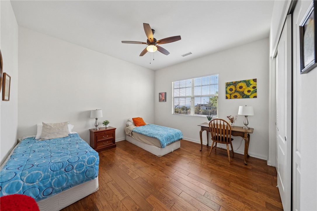 7774 Kingdom Drive Riverside, CA 92506 - Photo 42 of 66 a bedroom with furniture and a wooden floor