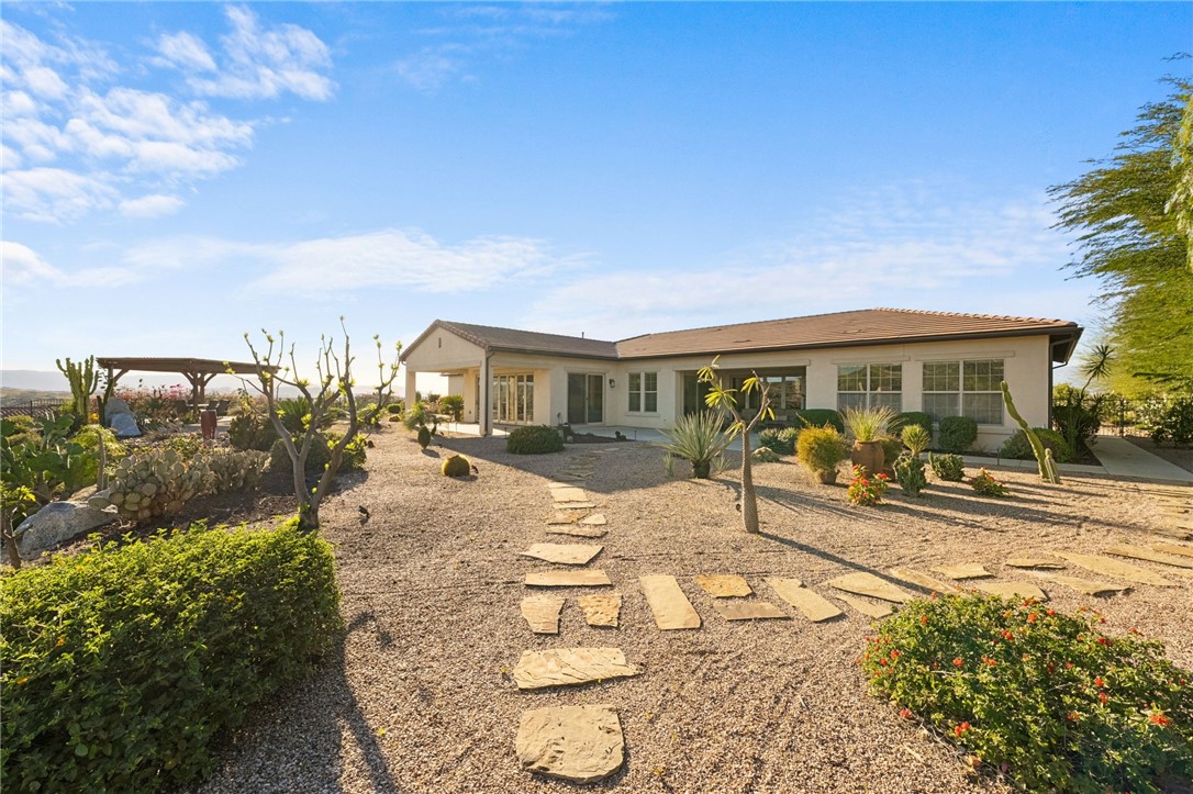 7774 Kingdom Drive Riverside, CA 92506 - Photo 54 of 66 a view of a patio with table and chairs and potted plants