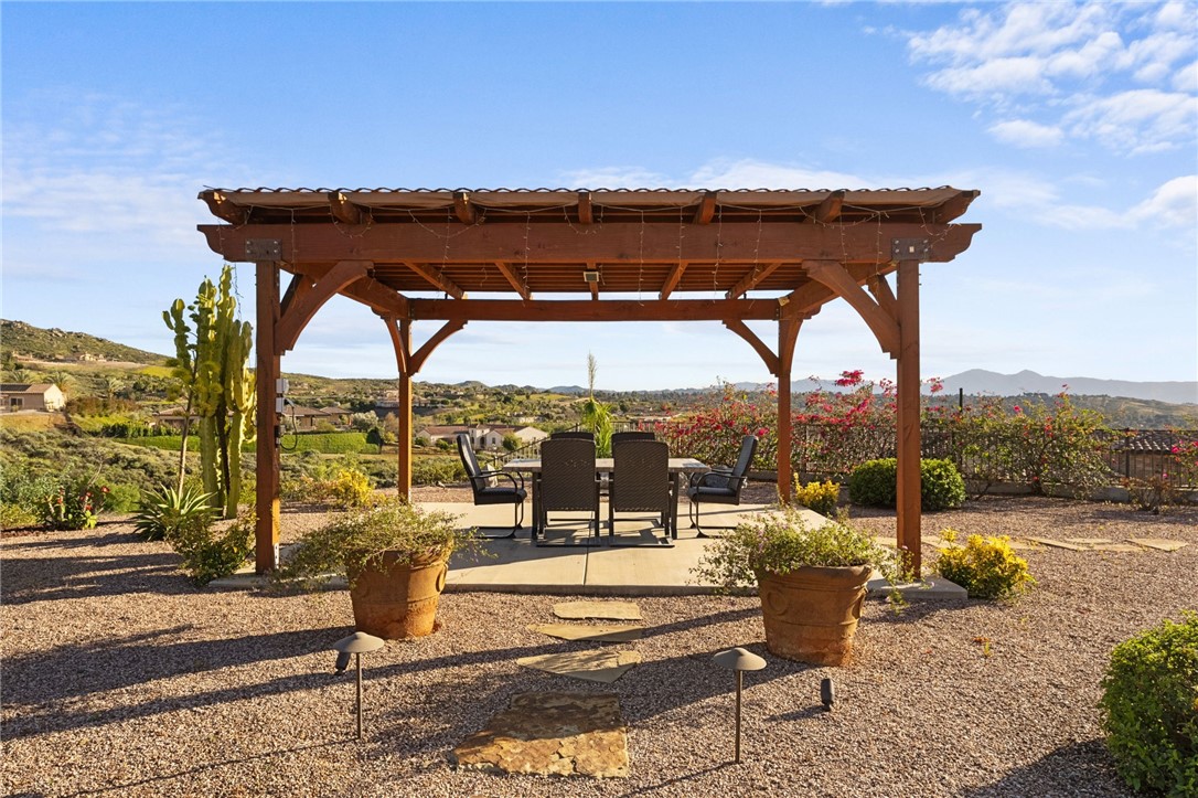 7774 Kingdom Drive Riverside, CA 92506 - Photo 55 of 66 Freestanding pergola creates an inviting outdoor dining space with wide-open hillside and neighborhood views.
