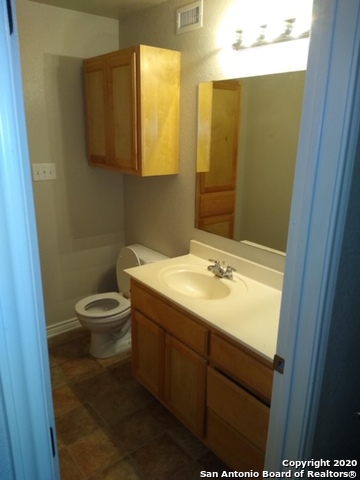 112 Lone Oak, Unit D102 Floresville, TX 78114 - Photo 30 of 34 a bathroom with a sink and a mirror