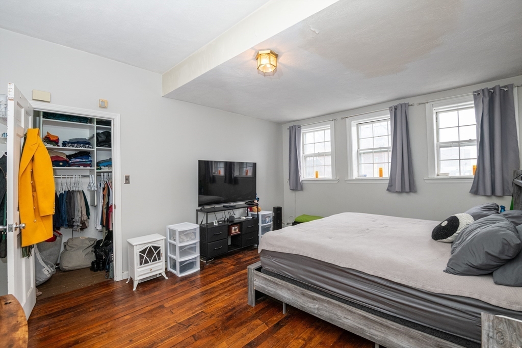 96 Derby Street, Unit 1 Salem, MA 01970 - Photo 11 of 31 a bedroom with a bed and a flat screen tv